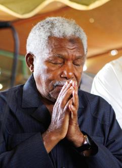 Former Tanzanian president Ali Hassan Mwinyi reacts after looking at the bodies of passengers killed in a ferry tragedy off the coast of Zanzibar on ... - P06-120721-317