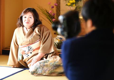 Yasue Tomita Sits On A Tatami Floor While Posing For A Photographer