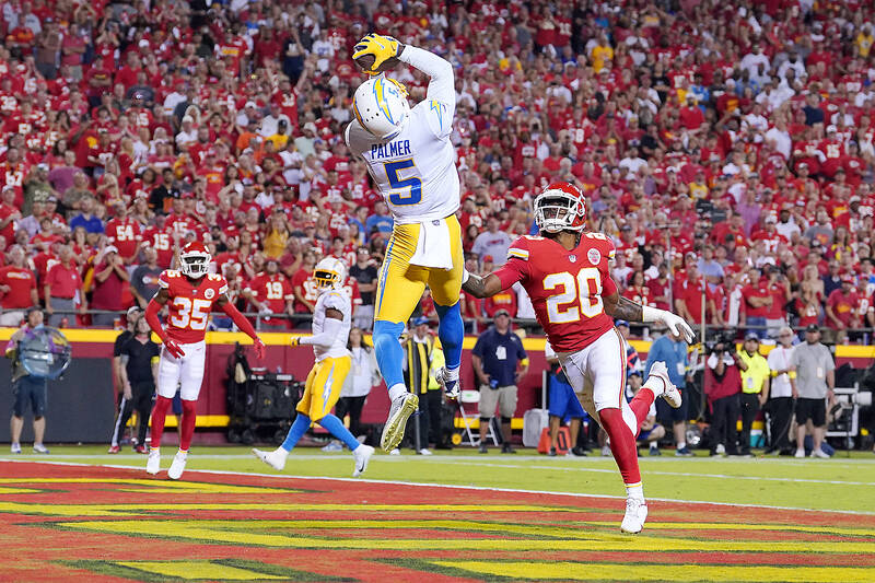 Sep 15, 2022; Kansas City, Missouri, USA; Los Angeles Chargers wide receiver Joshua Palmer (5) catches a touchdown pass against Kansas City Chiefs safety Justin Reid (20) during the second half at GEHA Field at Arrowhead Stadium. Mandatory Credit: Denny Medley-USA TODAY Sports